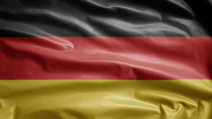 German flag waving in the wind. Close up of Germany banner blowing, soft silk.