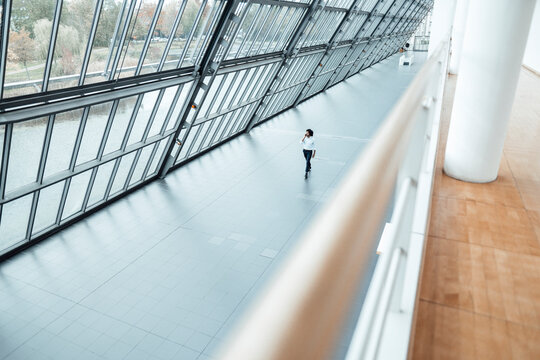 Young male entrepreneur walking by roof in office corridor