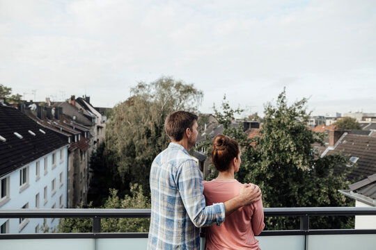 Mature couple standing spending leisure time together in balcony