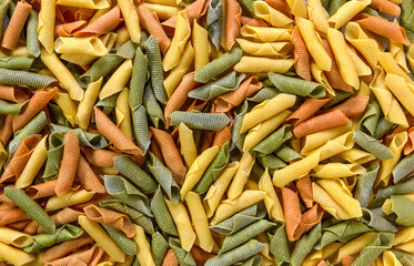A spread of coloured garganelli past as a background