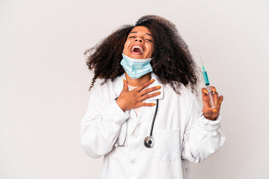 Young african american curly doctor woman holding a syringe laughs out loudly keeping hand on chest. - Powered by Adobe