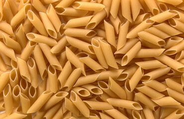 A spread of penne pasta as a background 
