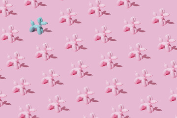 Pattern with pink ballon dogs on pastel pink backgroung with one intruder. Minimal flat lay concept.