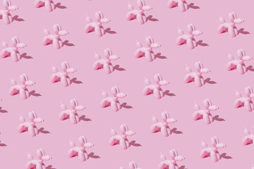 Pattern with pink ballon dogs on pastel pink backgroung. Minimal flat lay concept.
