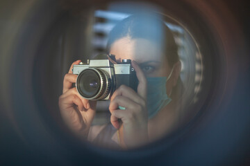 The photographer takes pictures with a retro camera. A look through the lens concept - 410279781