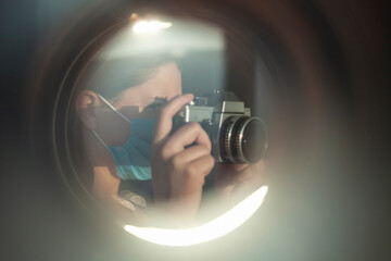 The photographer takes pictures with a retro camera. A look through the lens concept - 410279976