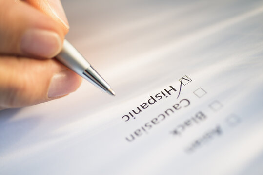 Close-up of hand filling out form