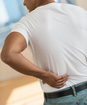 Man massaging his back