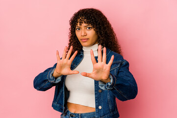 Young african american afro woman isolated rejecting someone showing a gesture of disgust.