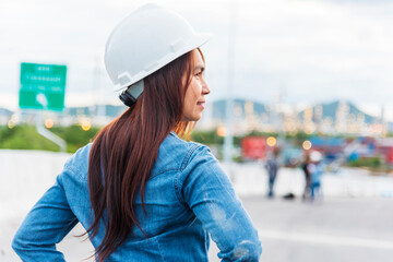 Woman engineer entrepreneur construction industry worker. Female engineer working refinery oil plant manufacturing. Young civil engineering construction wear hard hat safety helmet construction site.