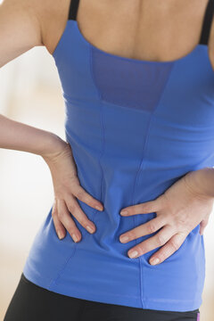 Midsection of woman with hands on back