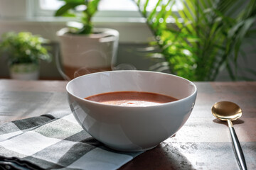 Piping hot bowl of tomato basil soup