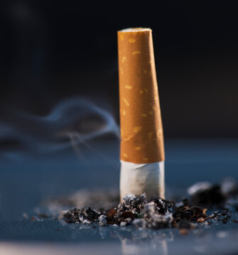 Close up of cigarette butt on black background