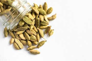 Green Cardamom Pods Spilled from a Spice Jar