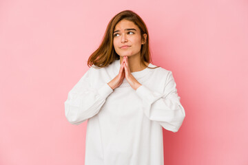 Young skinny caucasian teenager girl praying, showing devotion, religious person looking for divine...