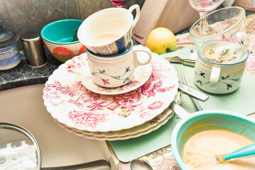 Dirty dishes and dishwashing in a wash basin. Unhygienic behavior 