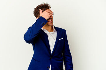 Young business caucasian man isolated on white background laughs joyfully keeping hands on head. Happiness concept.