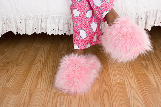 Close Up Of Girl's (10-11) Legs In Pajamas And Slippers