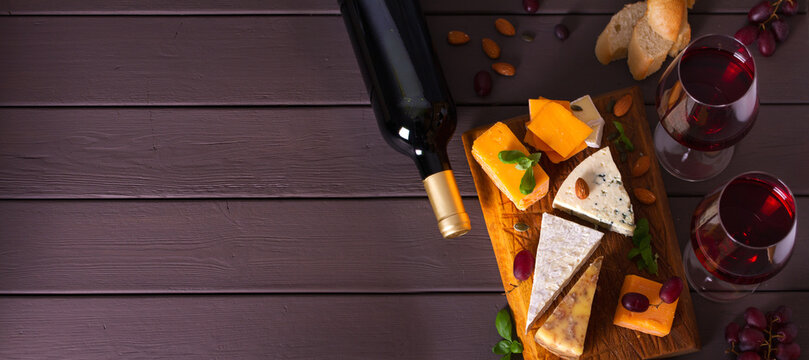 Glasses And Bottle Of Red Wine With Cheese And Nuts. View From Above, Top View. Copy Cpace, Banner