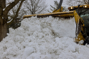 Snow removal equipment on a parking for cars road in winter snow background