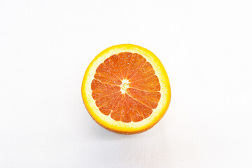 Orange cut in half top view on white background.