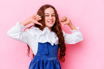 Naklejka premium Little caucasian girl isolated on pink background feels proud and self confident, example to follow.