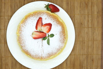 Homemade Fluffy Japanese Cheesecake, strawberries, knife