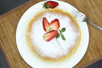Homemade Fluffy Japanese Cheesecake, strawberries, knife