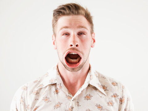 Studio Shot Of Man With Windblown Mouth