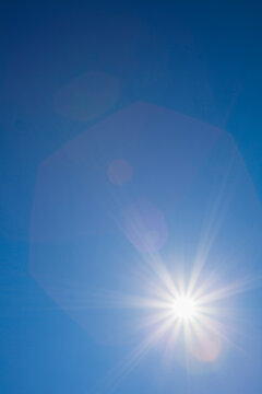Solar flare against blue sky