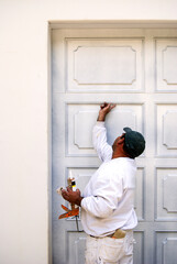 Painter caulking garage door panels