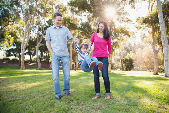 Family with daughter (4-5) playing in park