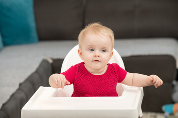 Beautiful Child Sitting in High Chair