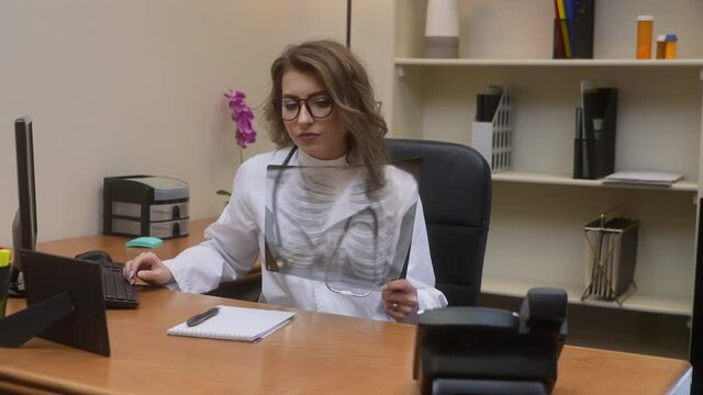 Defeated doctor buries her head in her hands out of frustration