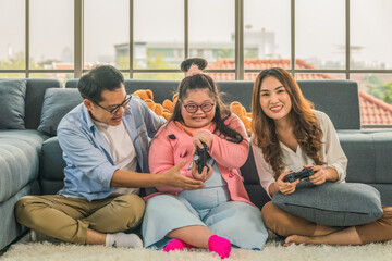 down syndrome teenage girl have fun play console game together with family
