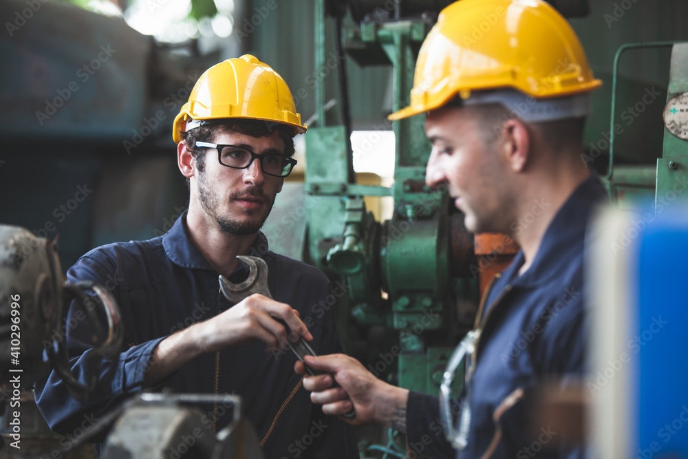 Wall mural two workers at an industrial plant. working together manufacturing activities.. worker and engineer 