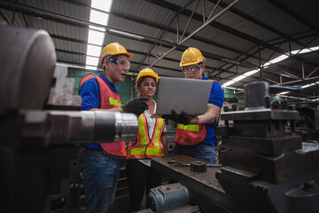 worker Industrial Engineers Talk with Factory Worker while Using Laptop. industrial worker is working. technician engineer and mentor checking process. machine metalworking industry concept copyspace