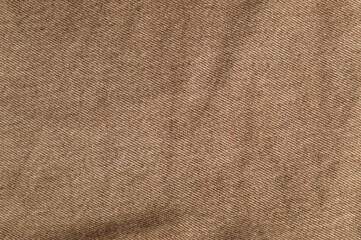 fabric grunge background, real cotton denim brown, wrinkled, frayed, close