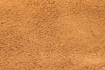 leather grunge background: an old piece of tough camel skin, with scuffs, spots, scars