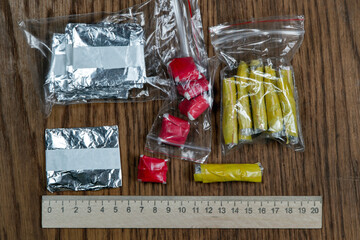 evidence of smuggling traffic: packages of unknown drugs next to the forensic scale
