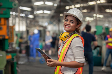 Engineer Female in using Tablet in Foundry worker in factory on the machine. portrait of an...