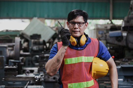 Portrait Of A Mechanical Worker. Asia Worker In Factory On The Machine