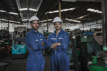 Portrait of an engineer at work in a factory. worker in factory on the machine