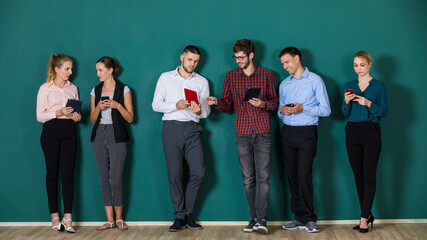 Group of six businesspeople colleague in modern company standing together in a row in front of the...