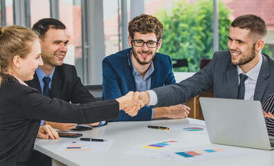 Group portrait of businesspeople team sitting in conference together in an office with intimate and unity manner. They are shaking hands. Idea for a good relationship of teamwork in business