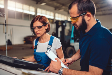 Quality Control Process Inspector monitoring CNC machine operator