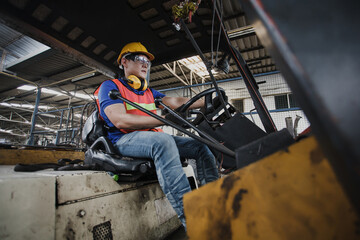 Fototapeta na wymiar worker forklift driver working in industrial factory or warehouse. worker Asia
