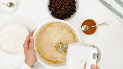 Chocolate Chip Cookies recipe. Mixing cookie batter in a bowl, close up view from above