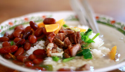 Rice and red kidney bean soup on plate. Indonesian food. 