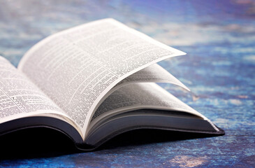 Bible Open on a Rustic Blue Wooden Table